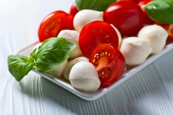 Mozzarella with tomato and basil — Stock Photo, Image