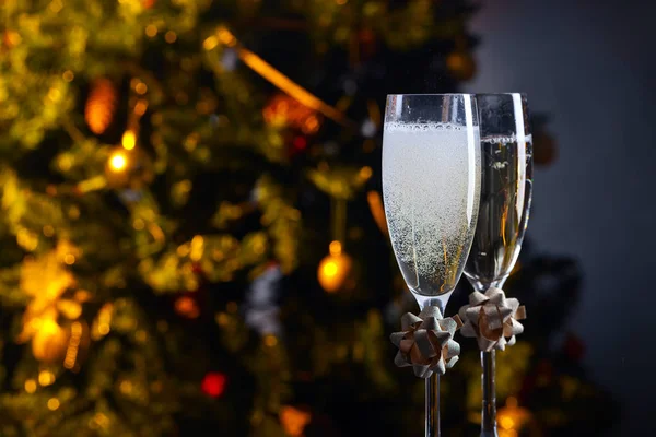Two glasses with champagne and Christmas ornaments — Stock Photo, Image