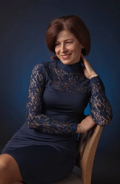 Portrait of a middle age woman in blue dress — Stock Photo, Image