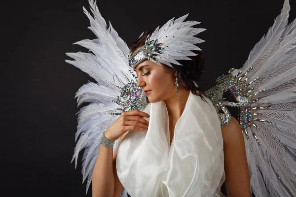 Beautiful young model wearing a white dress with angel wings in — Stock Photo, Image