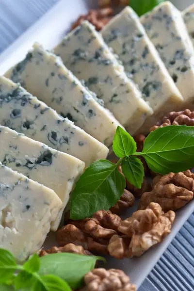 Blue cheese with green basil — Stock Photo, Image