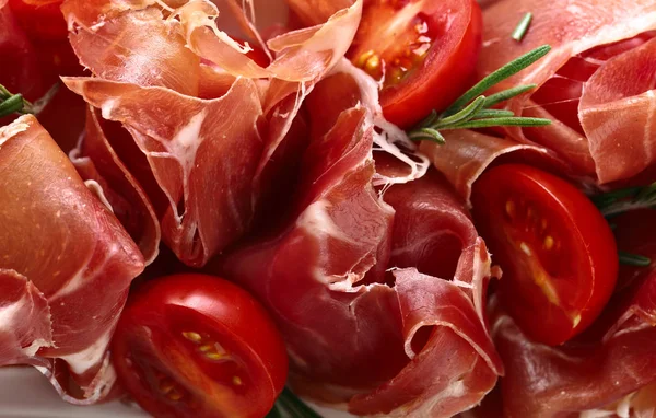 Prosciutto with  rosemary and tomato — Stock Photo, Image