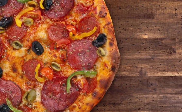 Fresh baked pizza with salami , olives and paprika — Stock Photo, Image