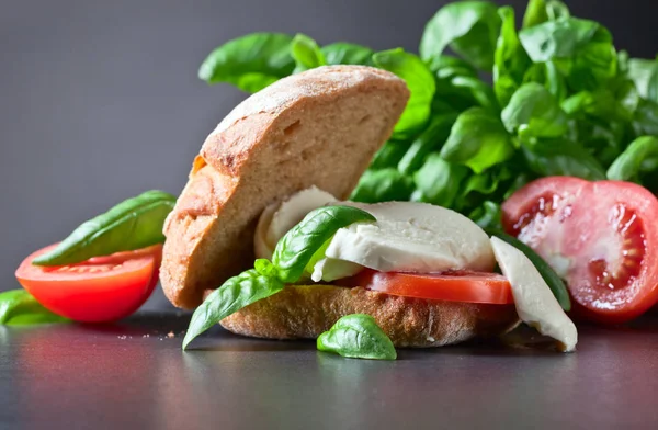 Sandwich with mozzarella, tomato and basil — Stock Photo, Image