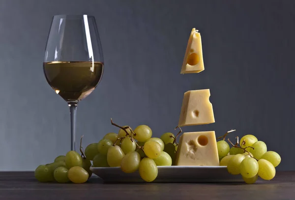 Magic cheese with grape and glass of wine — Stock Photo, Image