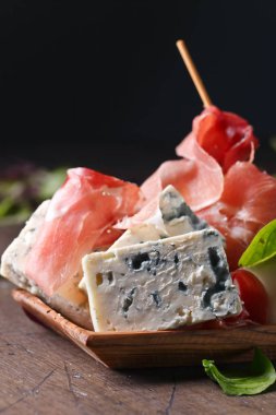 mavi peynir jambon ve ahşap bir masa üzerinde armut ile