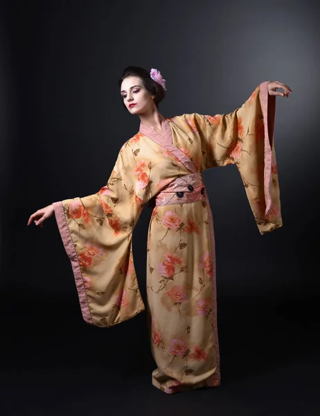 Siyah arka plan üzerine geleneksel Japon kimono içinde dans eden kadın — Stok fotoğraf