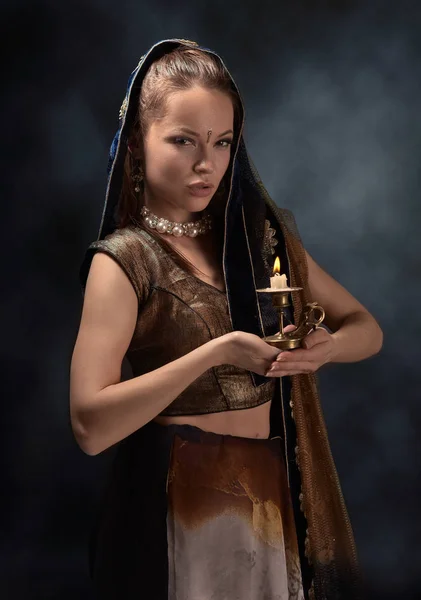 Portrait of a young woman with candlestick in sari — Stock Photo, Image