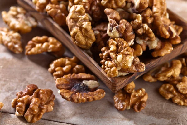 Walnuts in old wooden dish — Stock Photo, Image