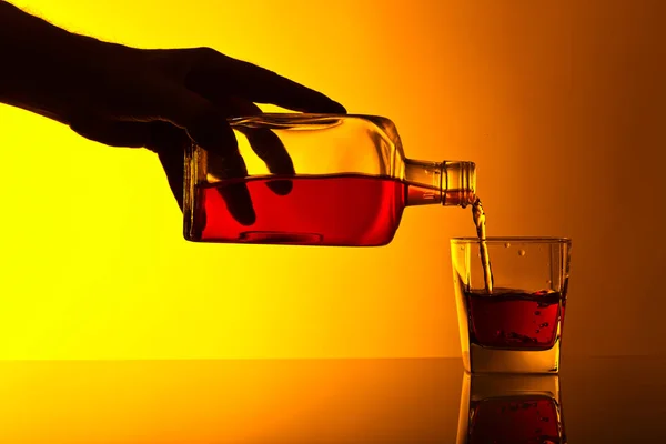 Flaska och glas whiskey på ett glasbord — Stockfoto
