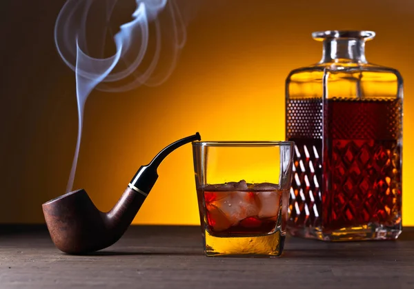 Glass of whiskey with natural ice on a wooden table — Stock Photo, Image