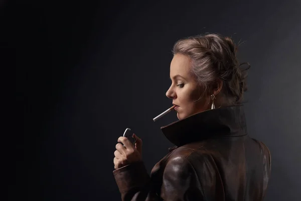 Portrait of young beautiful woman in brown leather coat