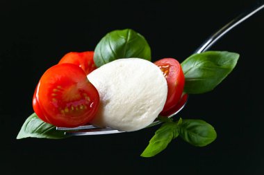  Mozzarella peyniri kiraz domates dilimleri ve yeşil fesleğen ile 