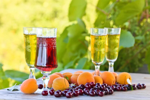 Glasses of sweet white and fruits on wooden table — Stock Photo, Image