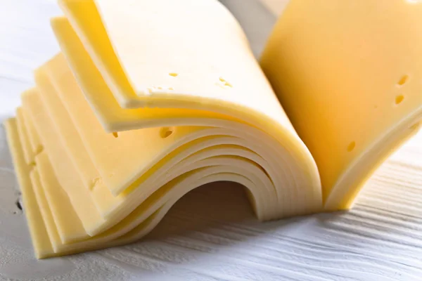 Slices of cheese folded like a book — Stock Photo, Image