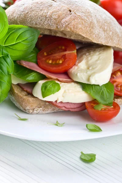 Ciabatta with ham , mozzarella, tomato and basil — Stock Photo, Image