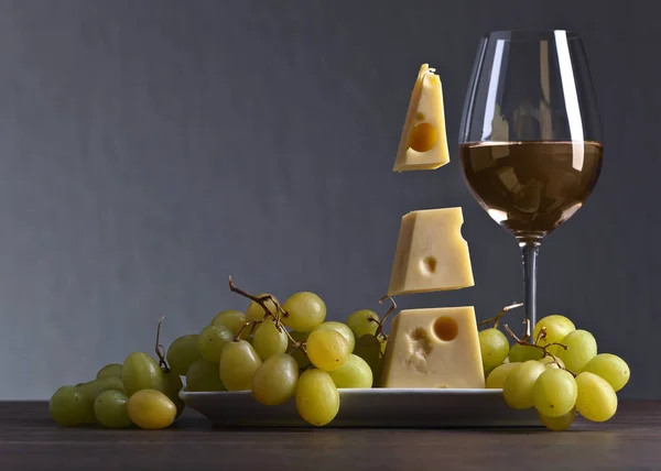 Magic cheese with grape and glass of wine — Stock Photo, Image