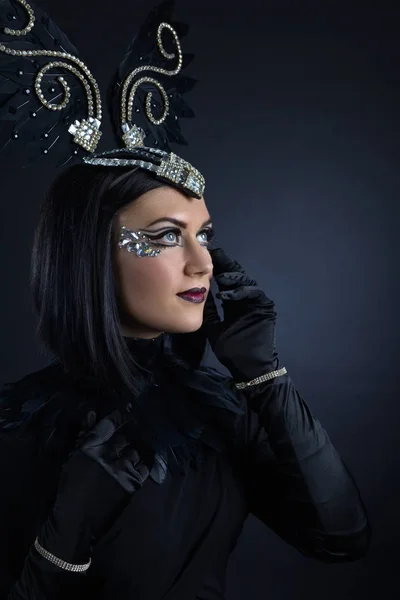 Woman in black with ornaments of rhinestone and feathers — Stock Photo, Image