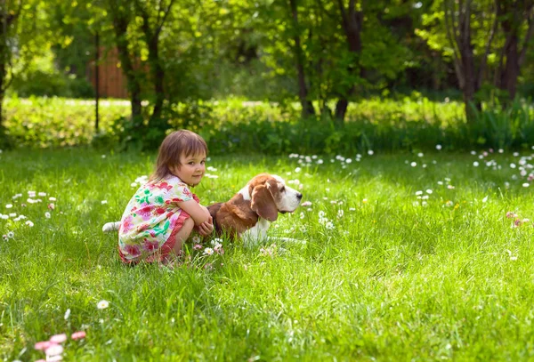 Küçük kız'ın bahçesinde bir köpekle oynayan . — Stok fotoğraf