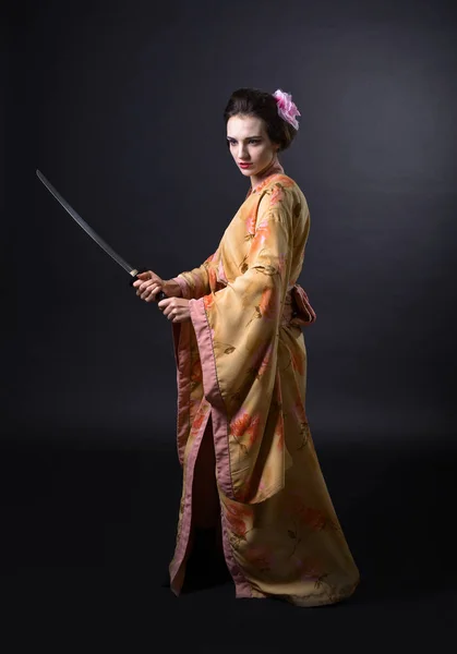 Woman in kimono with sword.