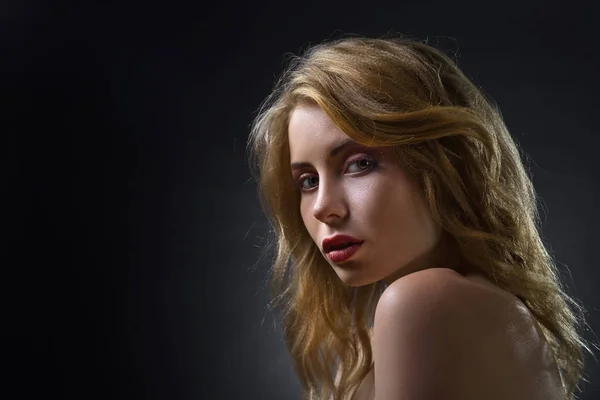Attractive blonde woman on dark background . — Stock Photo, Image