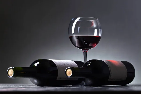 Бутылки и бокал красного вина  . — стоковое фото