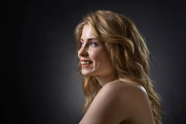 Attractive blonde woman on dark background . — Stock Photo, Image