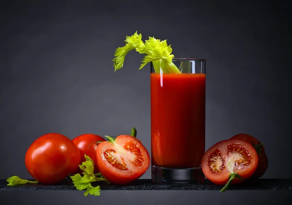 Tomato juice with tomatoes and celery sticks — Stock Photo, Image