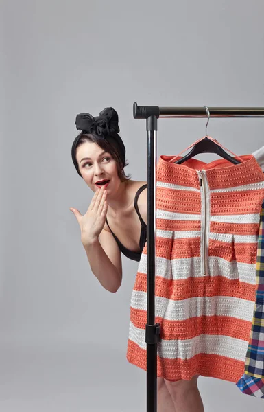 Woman in black bikini chooses clothes. — Stock Photo, Image