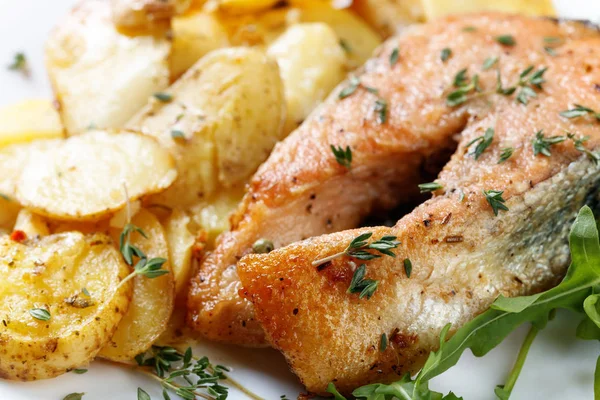 Roasted  salmon with  potatoes. Royalty Free Stock Images