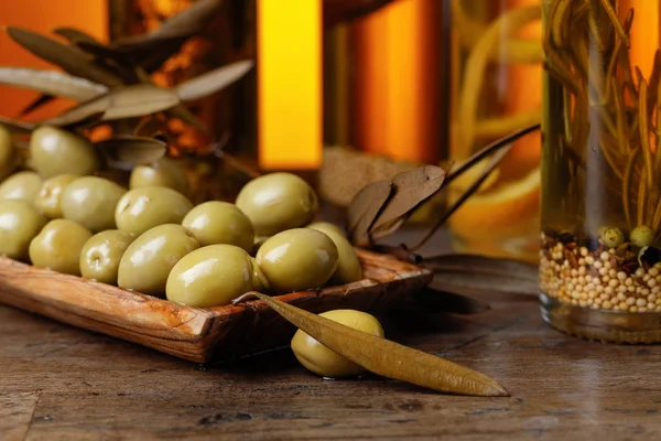 Green olives and bottles of olive oil . — Stock Photo, Image