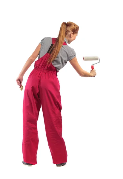 Young woman with a paintbrush and roller . — Stock Photo, Image