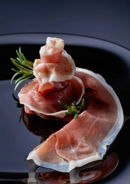 Prosciutto with rosemary. — Stock Photo, Image