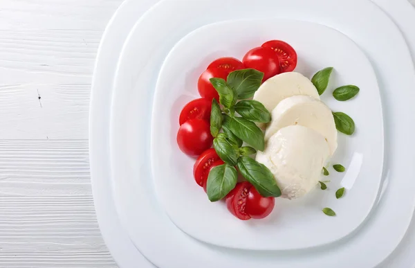 Mozzarella with tomato and  basil. — Stock Photo, Image