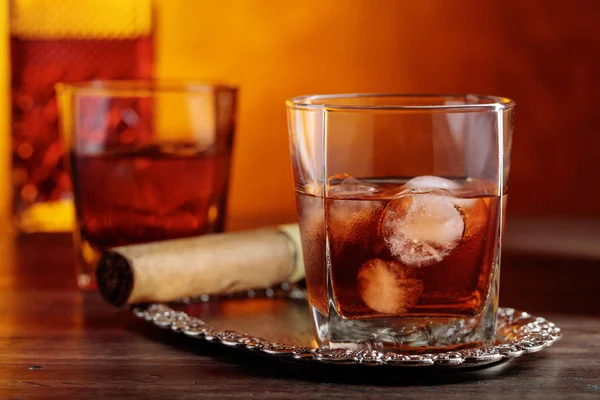 Glass of  whiskey and cigar on old wooden table. — Stock Photo, Image