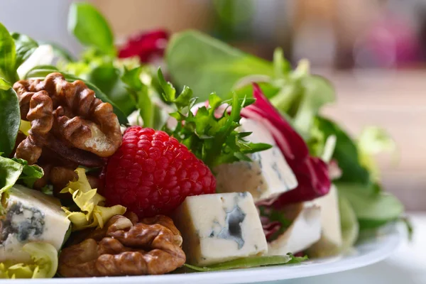 Ensalada verde con queso azul, frambuesa y nueces . — Foto de Stock