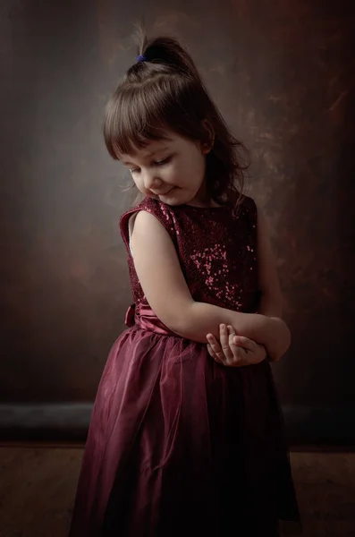 Little girl posing in red evening dress . — Stock Photo, Image