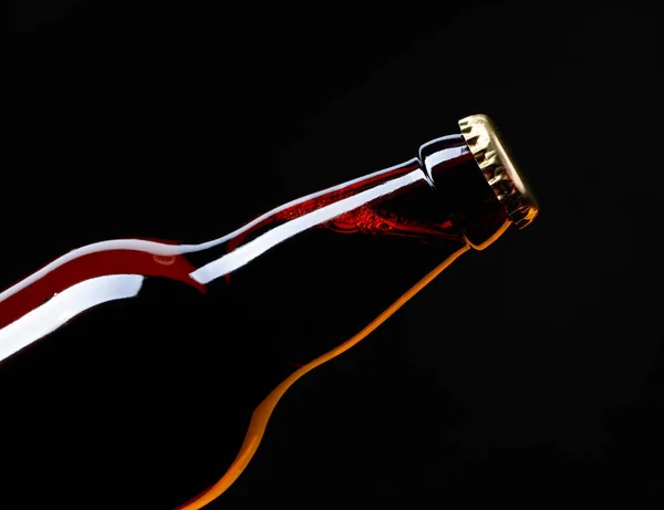 Closed  bottle of beer on a black background. — Stock Photo, Image