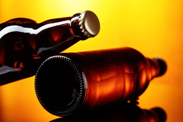 Closed  bottles of beer on a brown background. — Stock Photo, Image