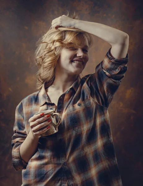 Young beautiful woman in plaid shirt with coffee mug . — Stock Photo, Image