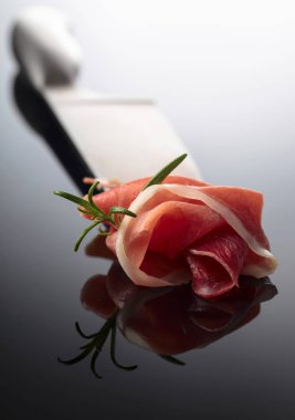  Siyah yansıtıcı arka planda biberiyeli jambon.. 