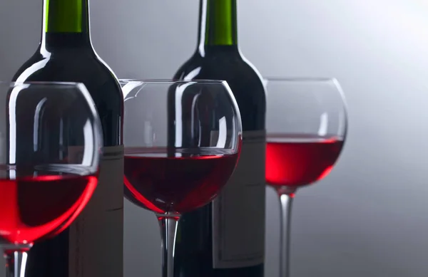 Bottles and glasses of red wine — Stock Photo, Image