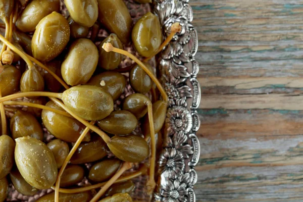 Pickled caper berries in metal dish . — Stock Photo, Image