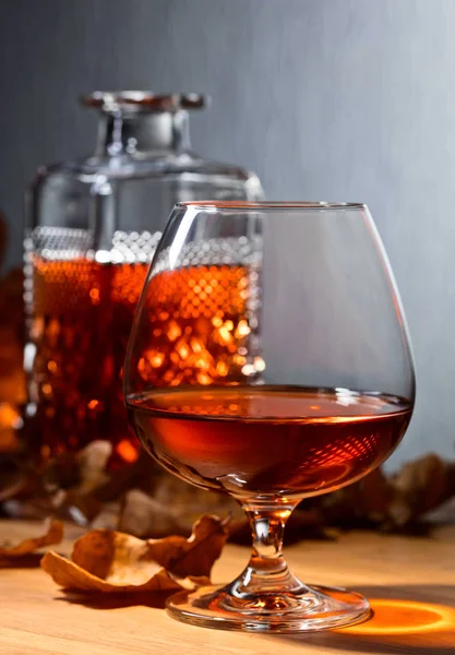 Brandy and dried up oak leaves . — Stock Photo, Image
