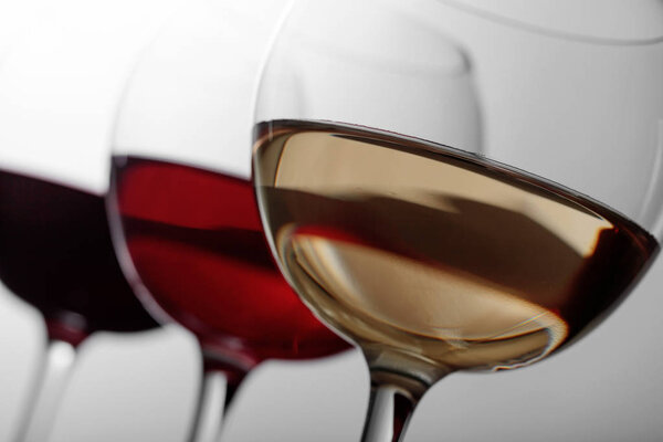 Glasses of  pink , red and white wine .