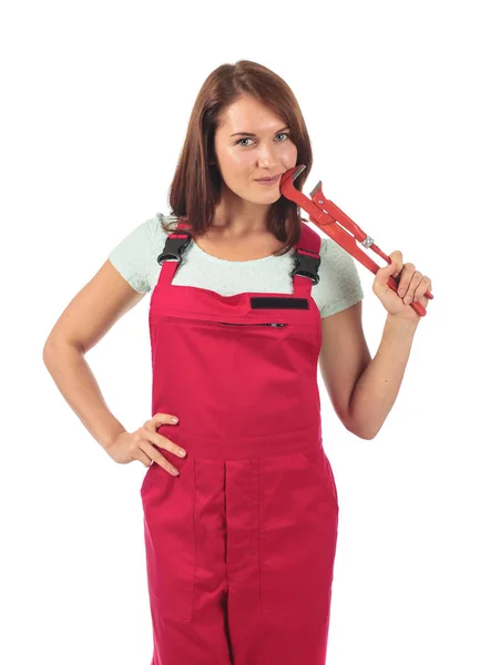 Young woman in red jumpsuit with wrench in hand, isolated on whi — Stock Photo, Image