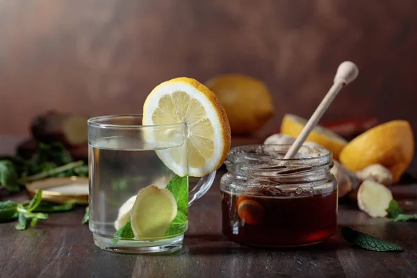 Té de jengibre con miel, limón y menta sobre una vieja mesa de madera  . — Foto de Stock