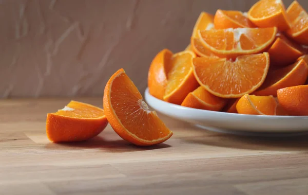 Cut tangerines on wooden table — Stock Photo, Image