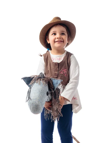 Cute little girl dressed like a cowboy playing with a homemade h — Stock Photo, Image