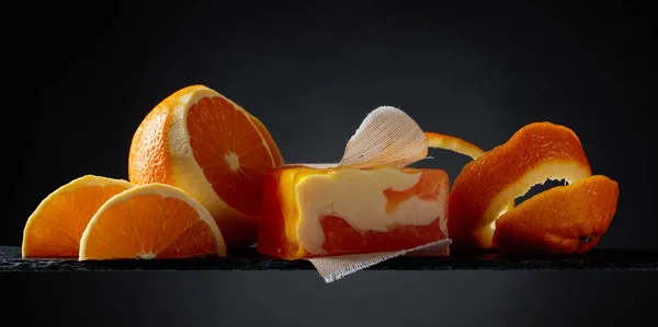 Bar of natural organic soap with orange on black background. — Stock Photo, Image